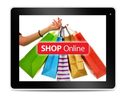 Paper shopping bags on computer tablet screen. Shopping online. E-commerce