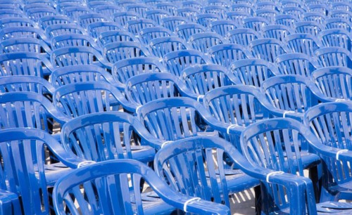 Many rows with a lot of blue pastic chairs