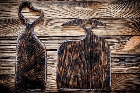 Two dark wood serving and chopping boards