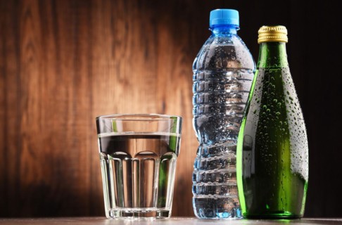 Composition with glass and bottles of mineral water