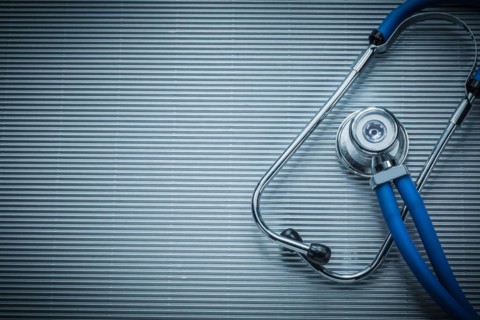 Medical auscultoscope on striped background