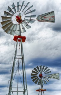 A vertical view of two wind wheels or wind pumps up close