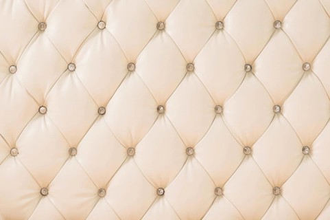 Beige soft tapestry pattern background with symmetrical buttons on the corners of diamonds. Soft