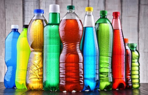 Plastic bottles of assorted carbonated soft drinks in variety of colors