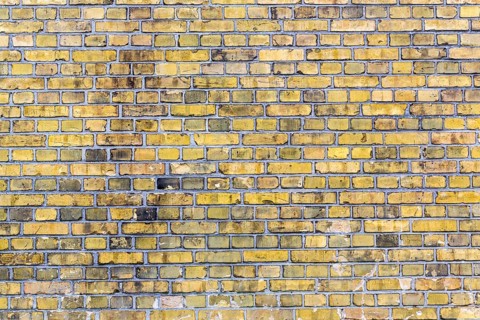 Old yellow brick wall for backgrounds