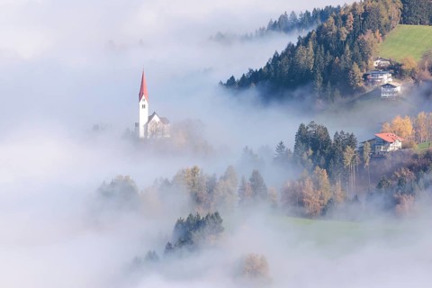 The Church of St. Peter in the fog, Weerberg, Tyrol, Austria