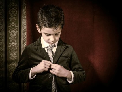 Boy in vintage black suit and tie