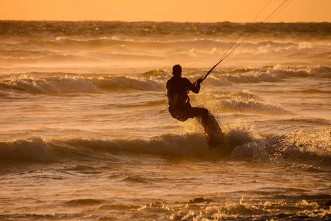Single surfer at sunset on a calm ocean