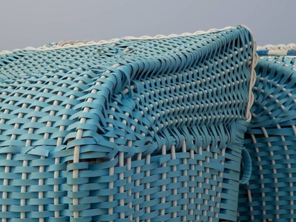 Close-up of a turquoise-coloured wicker beach chair, egmond, north sea, netherlands