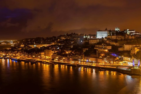 Overview of Old Town of Porto, Portugal at night. Ribeira and Douro river