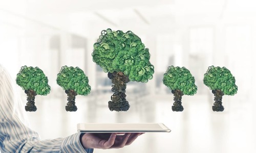 Close of businessman holding tablet pc with green tree made of gears and cogwheels. Mixed media