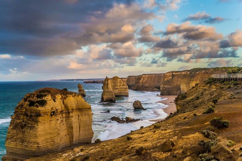 Travel to Australia. Pink dawn clouds over the rocks Twelve Apostles. Early morning on the ocean