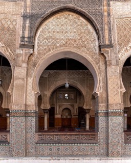 Fes, Morocco, April 05, 2023, Traditional oriental facade at the courtyard of madrasa Bou Inaniya