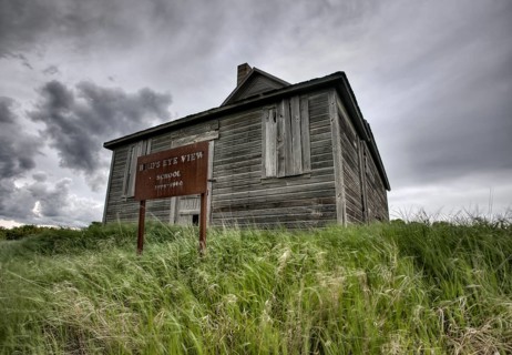 Abandoned Farm with storm clouds in the Canadian Prairie