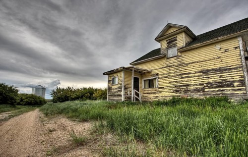 Abandoned Farm with storm clouds in the Canadian Prairie