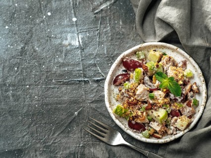 Waldorf salad with copy space. American fruit and nut salad with apples, celery, grapes, chicken