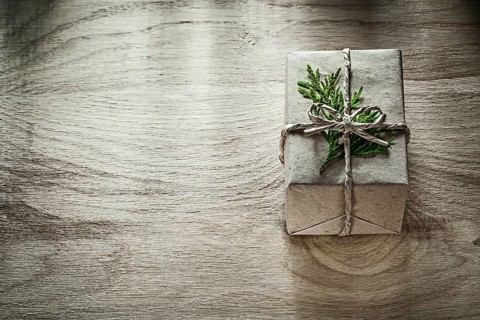 Handmade present box with thuya branch on wooden board