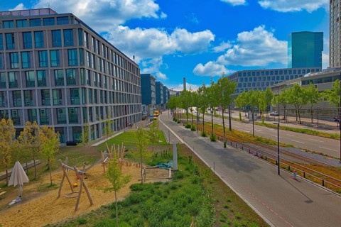 City view with playground and modern buildings under a clear blue sky, street scene,