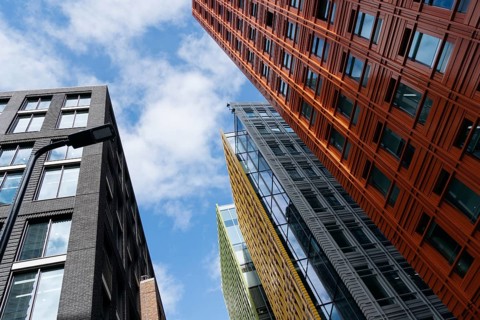 London, UK, August 27, 2023: Low angle view of modern and colorful apartment and office buildings