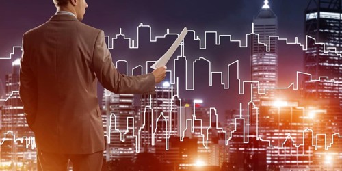 Man architect or engineer presenting construction concept and holding documents in hand