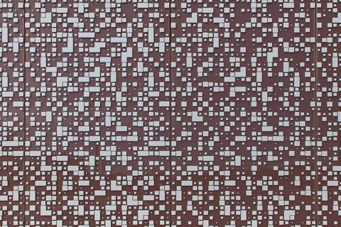 Closeup of randomly placed white tiles on painted concrete wall background texture