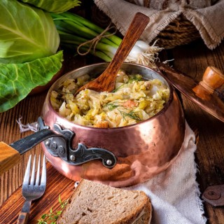 Young and fresh cabbage cooked with bacon cubes