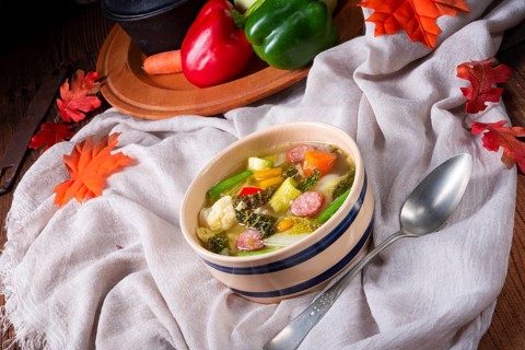 Delicious autumn vegetable soup with sausage and bacon