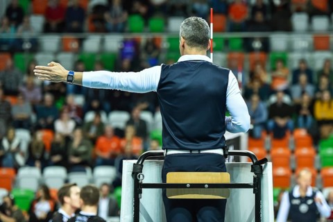 Volleyball first referee indicates a point for the team on the left