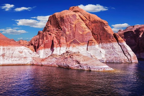 Lake Powell is surrounded by magnificent red hills. Walk on the boat at sunset. Scenic huge