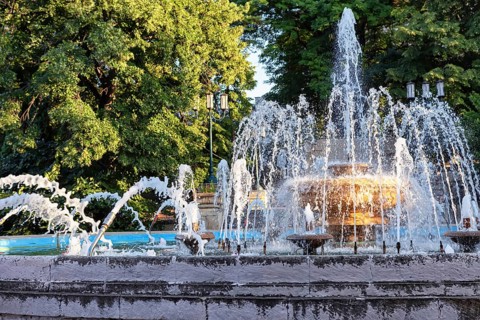 An old fountain with a large bowl in the centre and jets of different shapes in the resort park of