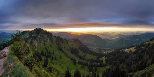 Panoramic view of a light and weather scene over the foothills of the Alps, taken from the