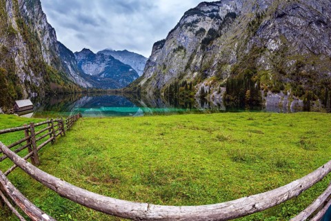 The concept of active tourism and ecotourism. Bavarian Alps. Magic blue lake Obersee and fenced