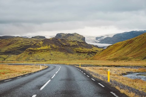 Road and mountain view during road trip in iceland. Foggy landscape in autumn time.
