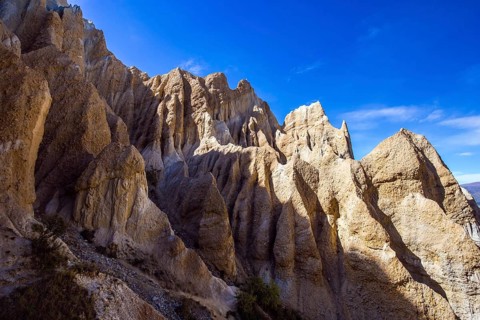 Jagged sharp pinnacles and ridges separated by narrow ravines. New Zealand, South Island. Clay