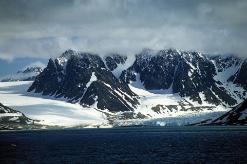 Snow-covered and glaciated rugged mountains surround the Magdalenefjord on Spitsbergen. Glaciers