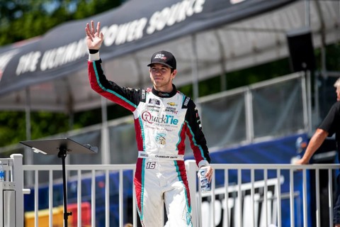 Chandler Smith walks across the stage during driver intros prior to the Road America 180 at Road
