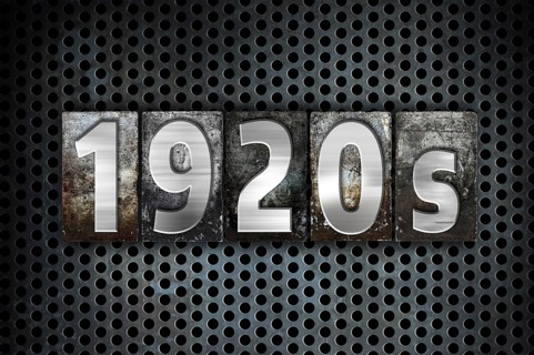 The word 1920s written in vintage metal letterpress type on a black industrial grid background