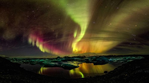 Northern lights aurora in Jokulsarlon glacial river lagoon