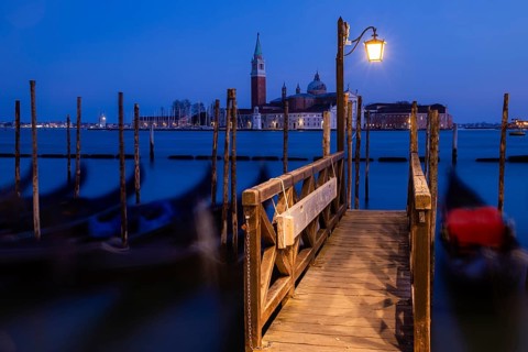 Venetian gondolas, boat dock at St Mark's Square, church of San Giorgio Maggiore in the background,