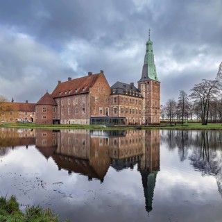 Water castle Raesfeld in Muensterland, North Rhine-Westphalia, Germany. View with reflection in the