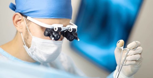 Medical professional using tools during a surgical procedure