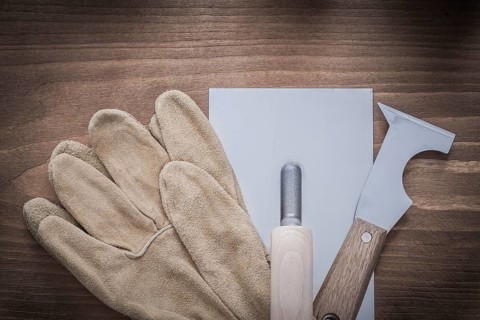 Putty knife plastering trowel and leather working gloves
