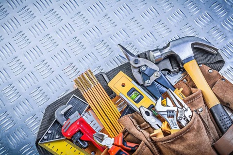 Tool belt with construction objects on corrugated metal pattern building concept