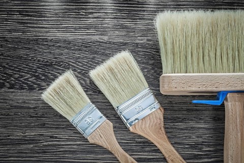 Paint brushes on wood board top view