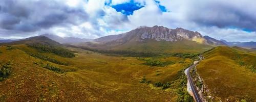 An aerial view of Gordon River Rd at the Sentinel range of mountains near Bitumen Bones Sculpture