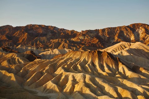 Precise mountain folds well-known Zabriskie-point in Death valley in the USA. A sunset