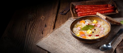 Rustic sauerkraut soup with bacon and sausage