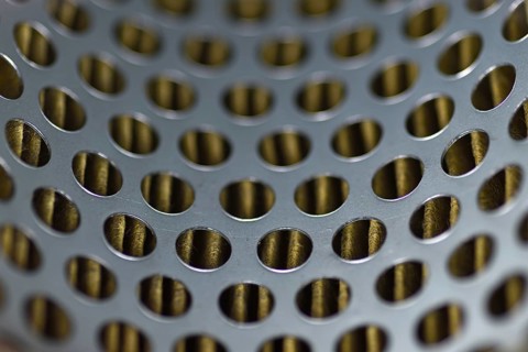 Detail of a tractor oil filter creates an industrial textured background