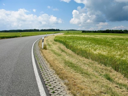 Perfect road in landscape with fields, trees, and blue sky, Germany