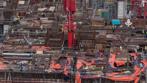 Workers busy with construction. Building a house in Kuala Lumpur, Malaysia